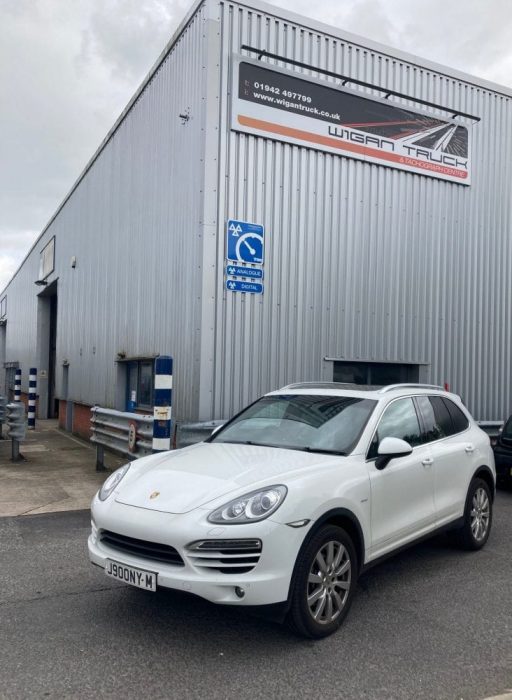 3 (2) A Porsche parked outside Wigan Truck